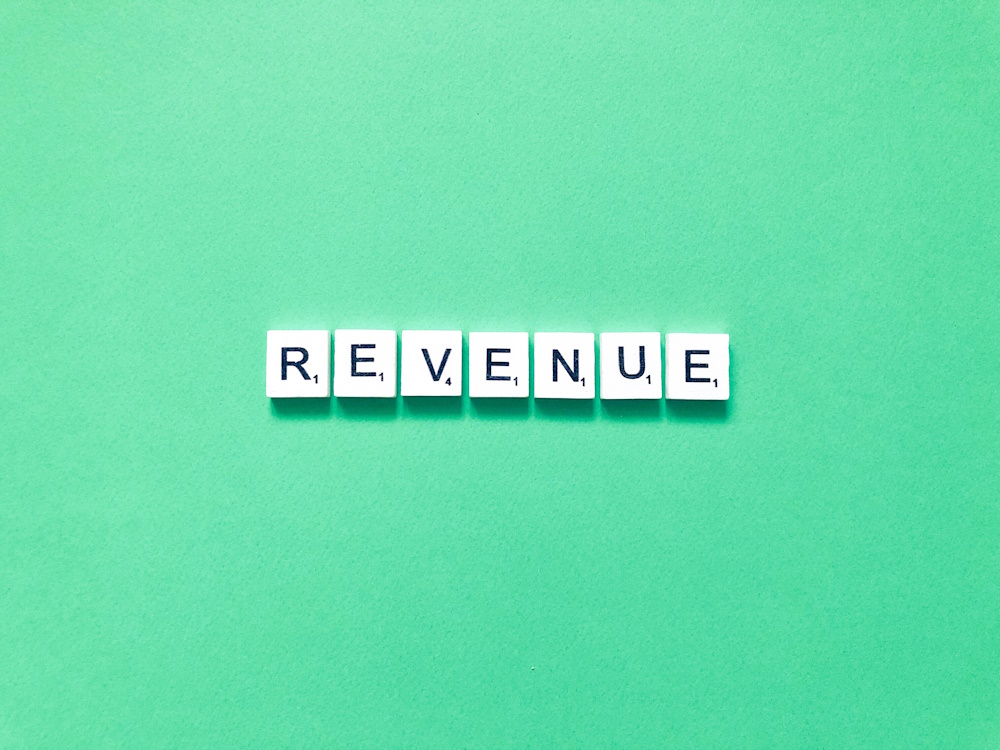 The word revenue on a green background