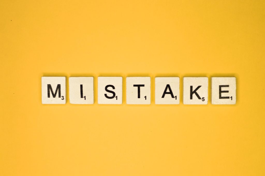 the word "mistake" spelled out in scrabble tiles